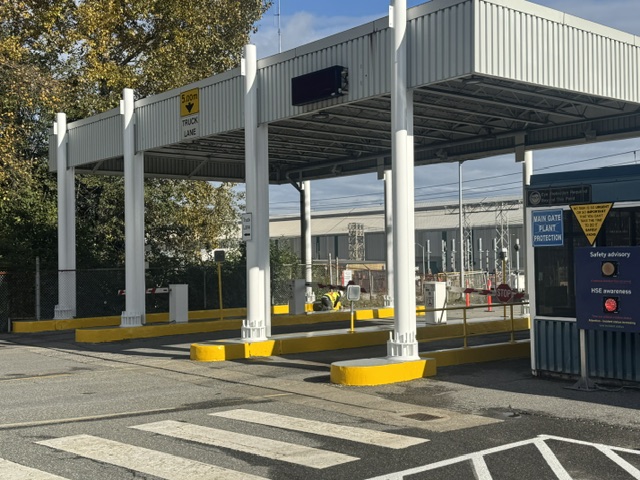 Painted bollards and curbs at a site gate
