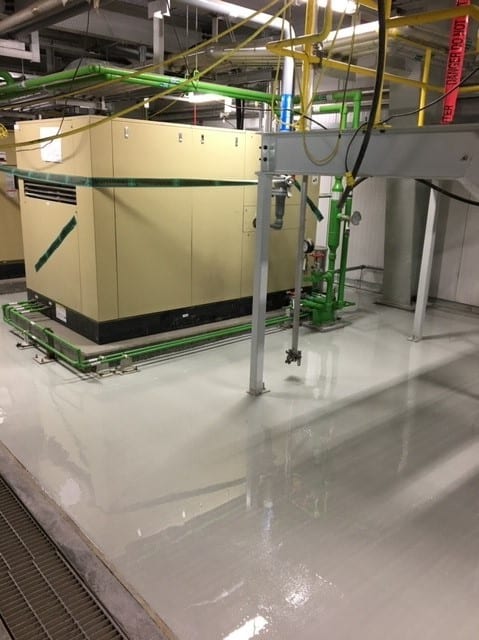 Coated floor around equipment in a turbine building