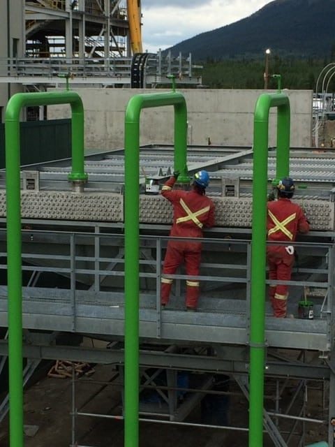 Crew coating piping at the biomass facility