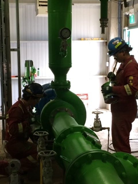 Crew working on coated piping