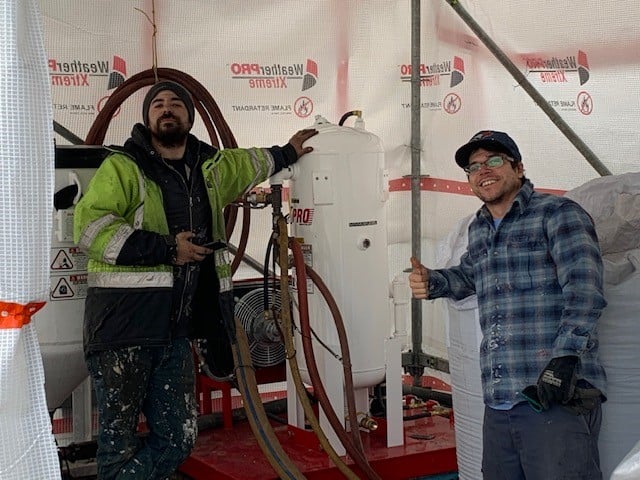 Red Seal crew with blast pot inside containment